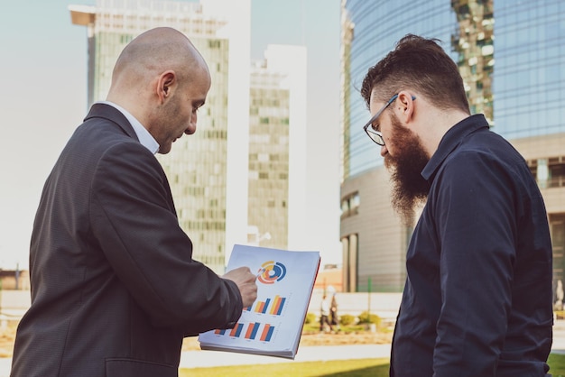 businessman-analyzes-current-investment-status-urban-projects-with-architect-businessman-comments-graphs-technical-analysis-with-creative-man-concept-business-coworking_164678-736.jpg